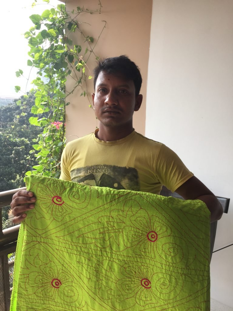 Nakshi Kantha trader Mohammed Hussain with one of his beautiful wares